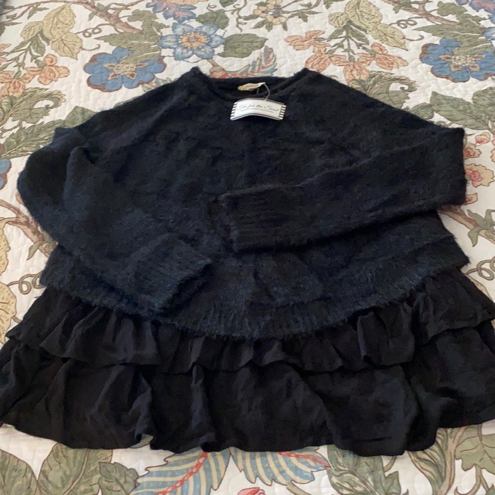 Ruffled bottom black sweater.